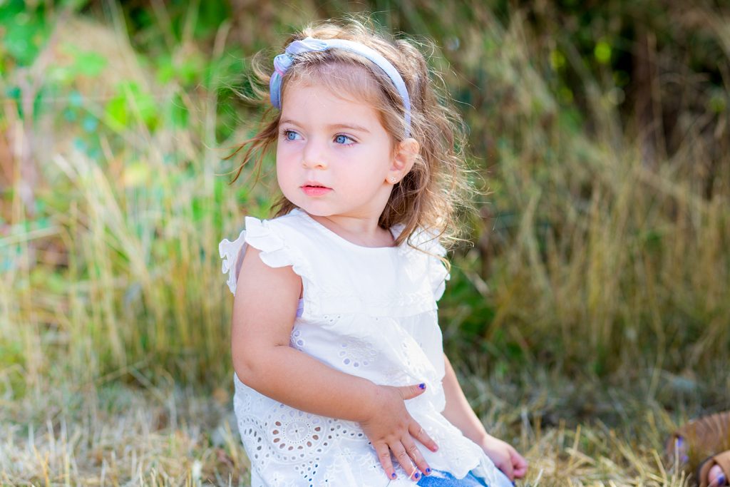 Pretty little girl sitting in the grass