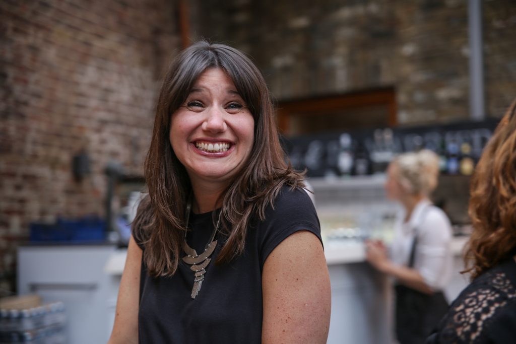 Woman at party smiling at the photographer