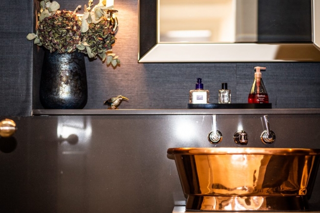 Downstairs bathroom showing bronze basin and dried flowers
