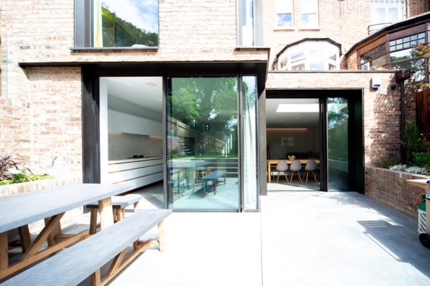 Back of house with glass sliding doors going into kitchen