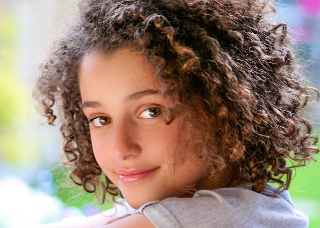 Pretty girl with ringlets looking over her shoulder