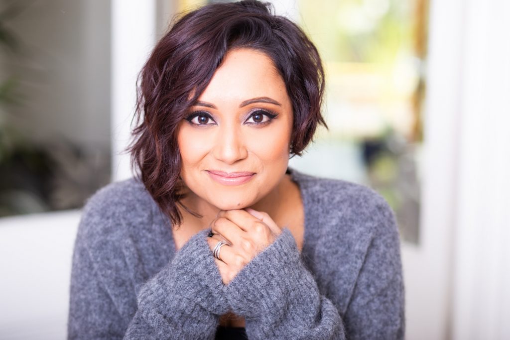 beautiful Asian woman in grey fluffy jumper smiling