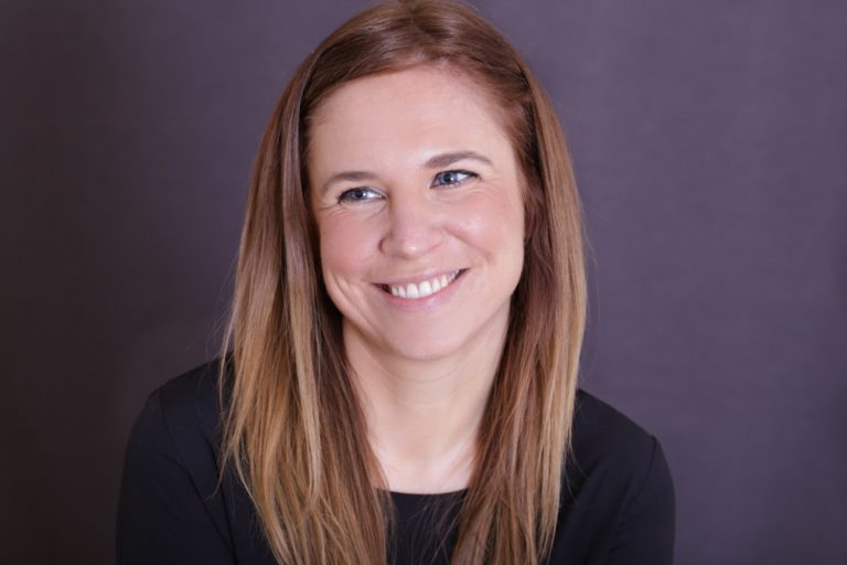 Smiling woman with purple background