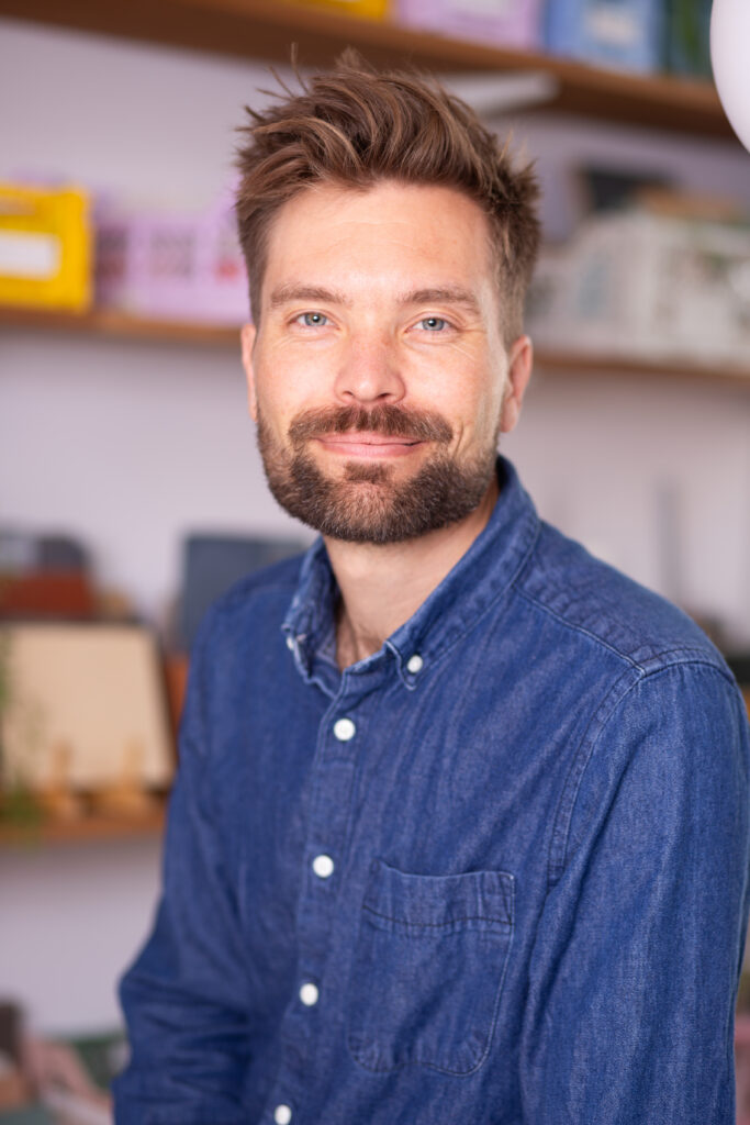 Dark-haired bearded man in blue shirt