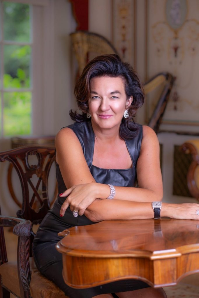 Business woman in black leather dress sitting at desk