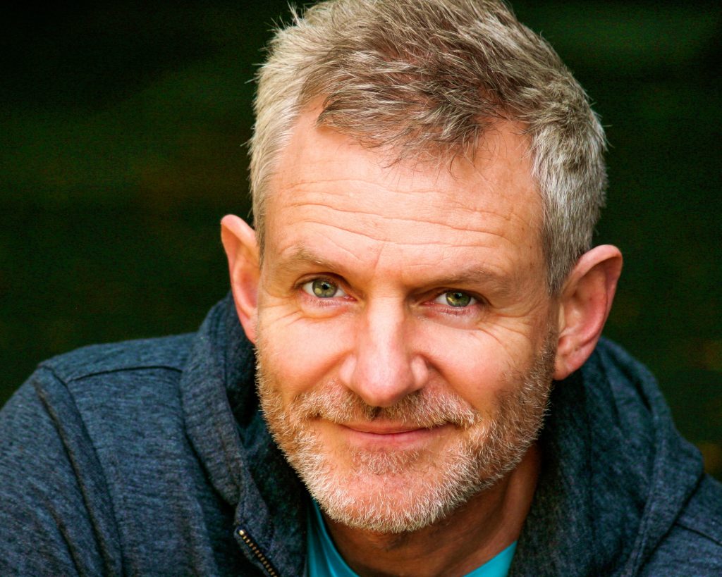 Handsome middle-aged man with salt and pepper coloured hair and beard