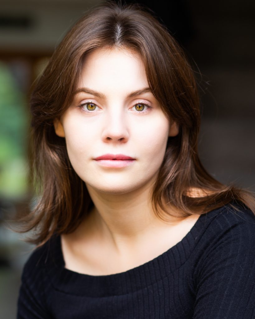 Young actress with green eyes and dark top