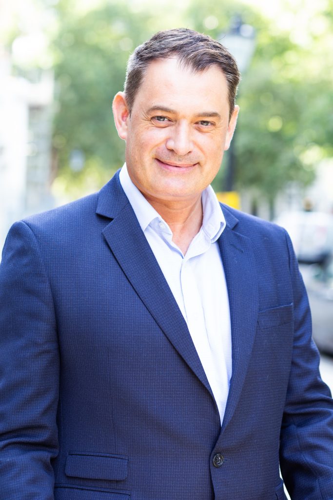 Man in corporate suit standing in the street