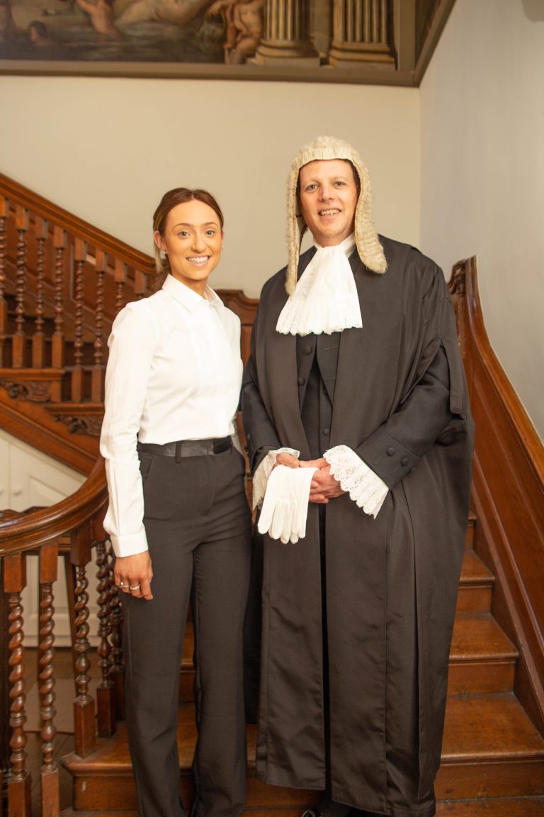 KC Barrister and clerk standing at bottom of stairs