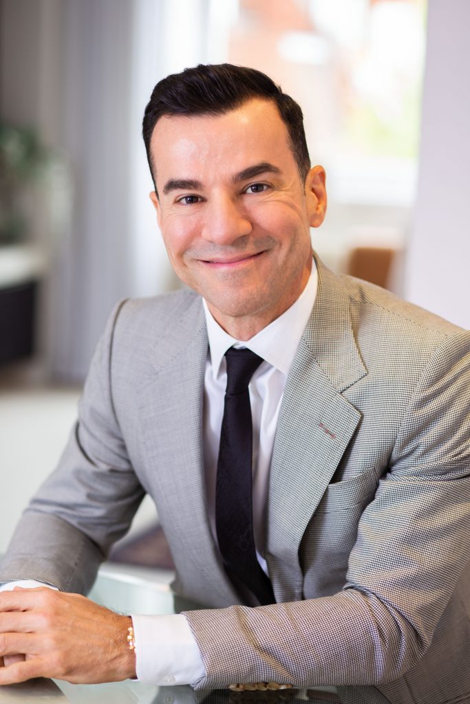 Friendly man in a suit sitting at a desk