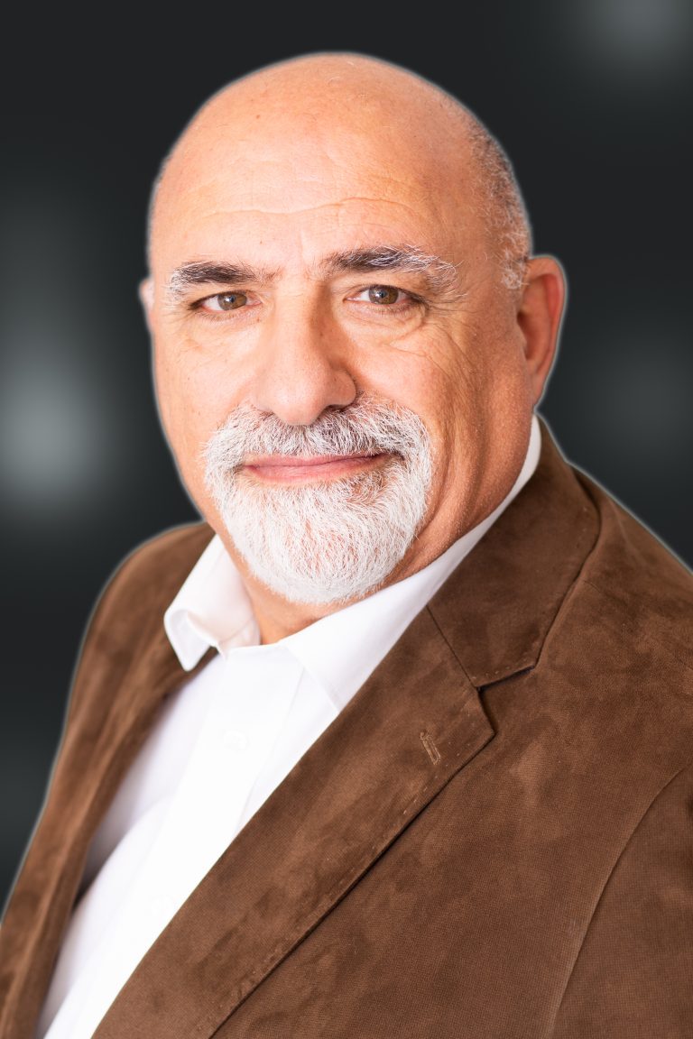 Older man in brown jacket and grey beard